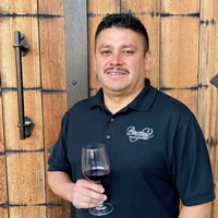 Carlos Valadez holding wine